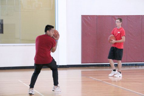 Both Austin Boyd, undecided freshman, and Kaleb Krjcarek education sophomore, take time for themselves to get a break from their schedules by playing basketball at the Wellness Center on Tuesday, Sept. 4, 2018. Photo by Cortney Wood