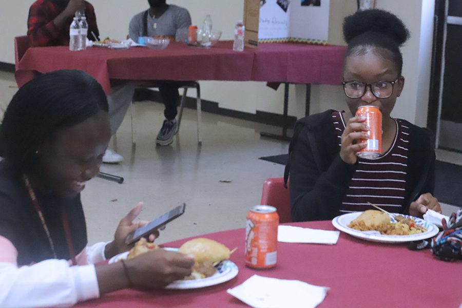 Nursing freshmen Gloria Olagoke and Nelly Nyangaresi enjoy the food at ASOs Taste of Africa.