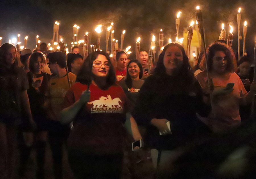 Students march in the Torchlight parade.