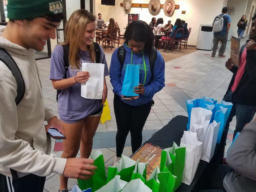 Ryan Acosta, Jacey Grimes, and Lanisa Small radiology sophomores picking up essentials from the UPB Stress Awareness booth in the Clark Student Center Wednesday Nov 7. 