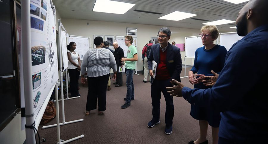 Don Wijesinghe  explains his poster to University President Suzanne Shipley at the Undergraduate Research and Creative Activities Forum, Nov. 15, 2018. Photo by Jake Clancy