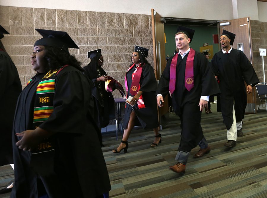 Cameron McEnturff walks over to the graduation ceremony from Yeager Coliseum at Midwestern State University graduation Dec. 15, 2018. Photo by Bradley Wilson