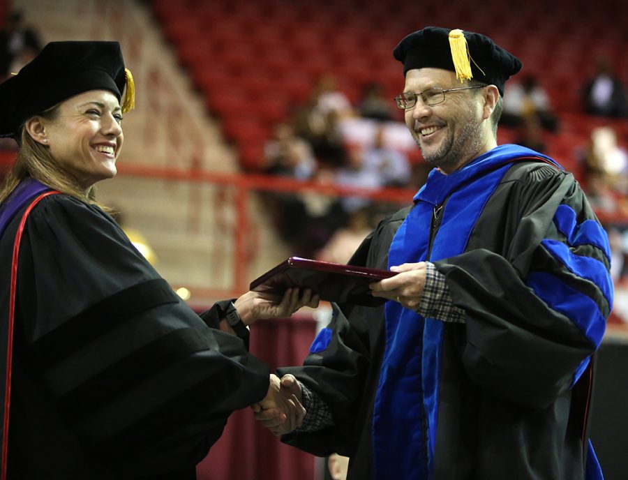Chris Hansen, associate professor of chemistry, receives the Faculty Award from Laura Fidelie at Midwestern State University graduation Dec. 15, 2018. Photo by Bradley Wilson