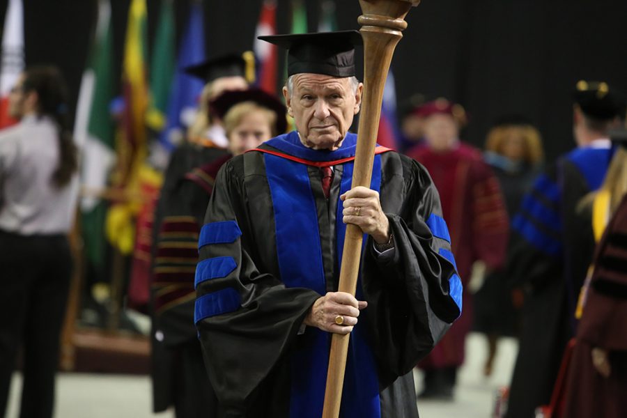 Harry P. Hewitt, professor and chair of the history department, leads the faculty out of graduation at Midwestern State University graduation Dec. 15, 2018. Hewitt is retiring as the longest-serving faculty after 51 years. Photo by Bradley Wilson