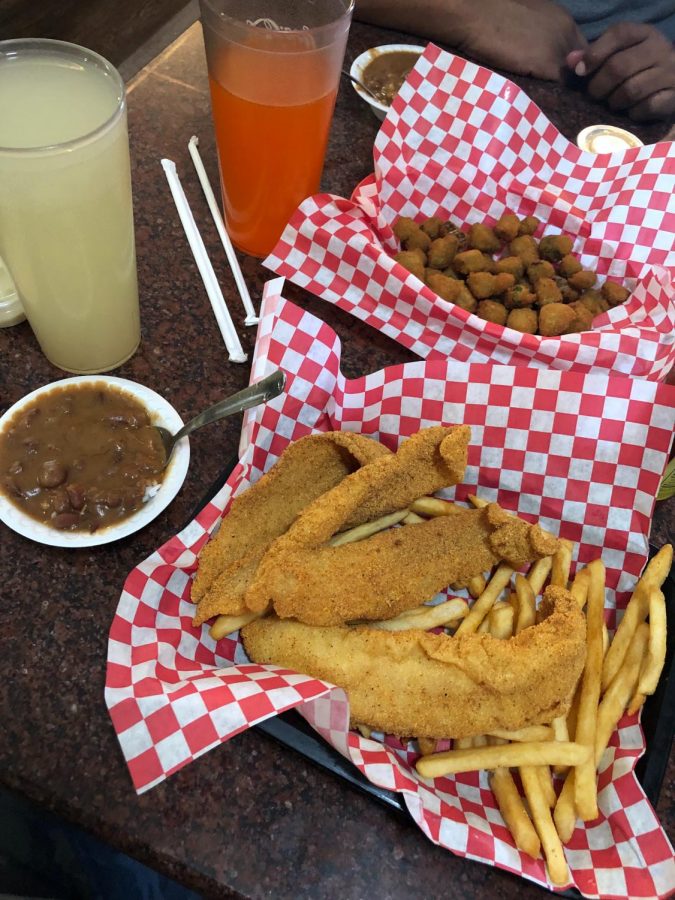 fried catfish, red beans and rice, fries, and fried okra with drinks on the side