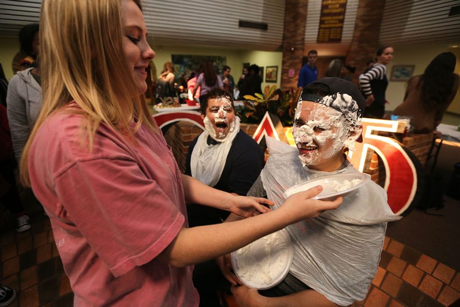 Abigail Mathews, a nursing freshmen, pies Michael Gonzales and Jorge Morales at Omega Delta Phi Pie a Phi event in Clark Student Center. Photo by Bradley Wilson