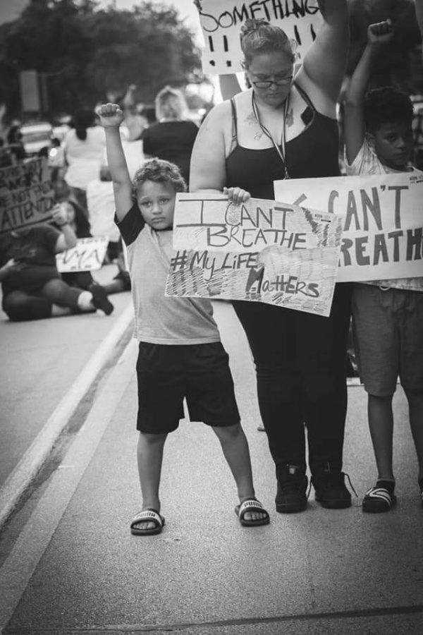 Jordan, 7, raises his fist in the air at the Wichita Falls #icantbreathe protest. June 1. Photo by Katie Bindel