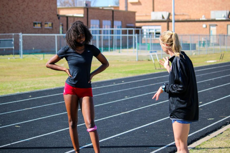 Track coach Kelsey Bruce, gives one of her athletes pointers on running form