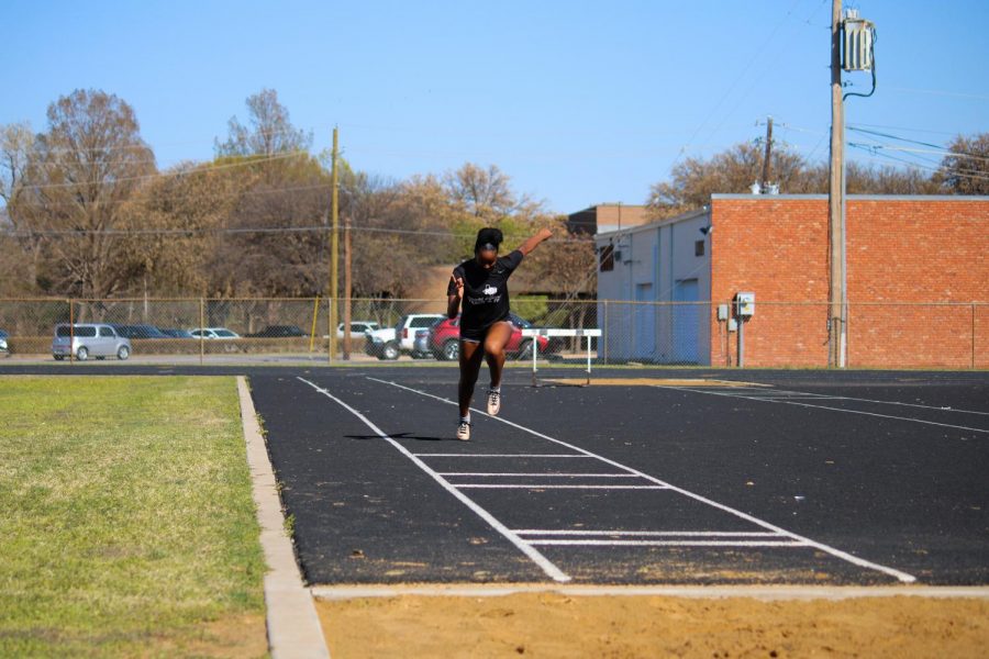 Finance sophmore, Peyton Lewis, practices long jump in an effort to futher her abilities.