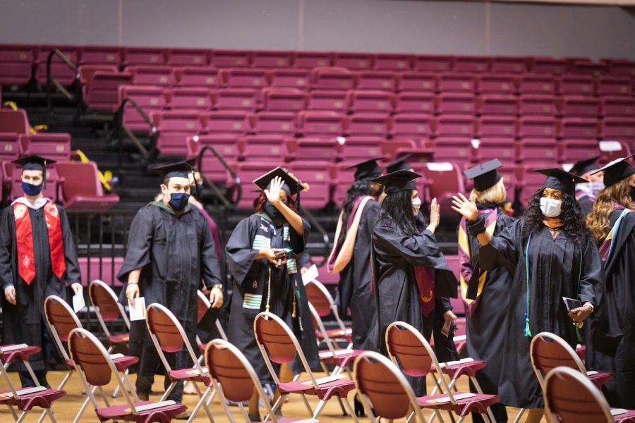 MSU graduate students greet the crowd before the graduation ceremony begins, April 30.