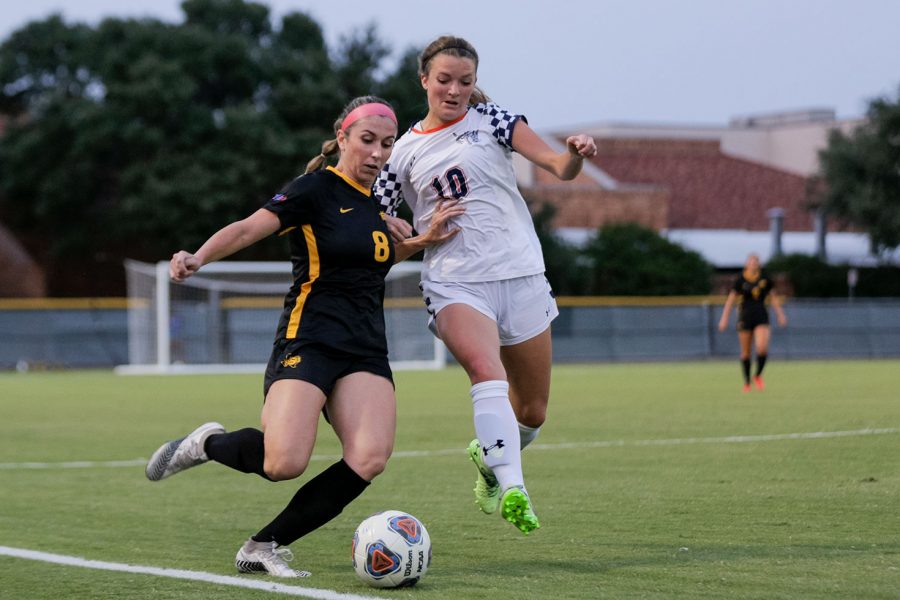 Radiology senior and midfielder Kelly Cannistra keeps the ball on the field despite pressure from a Mines player