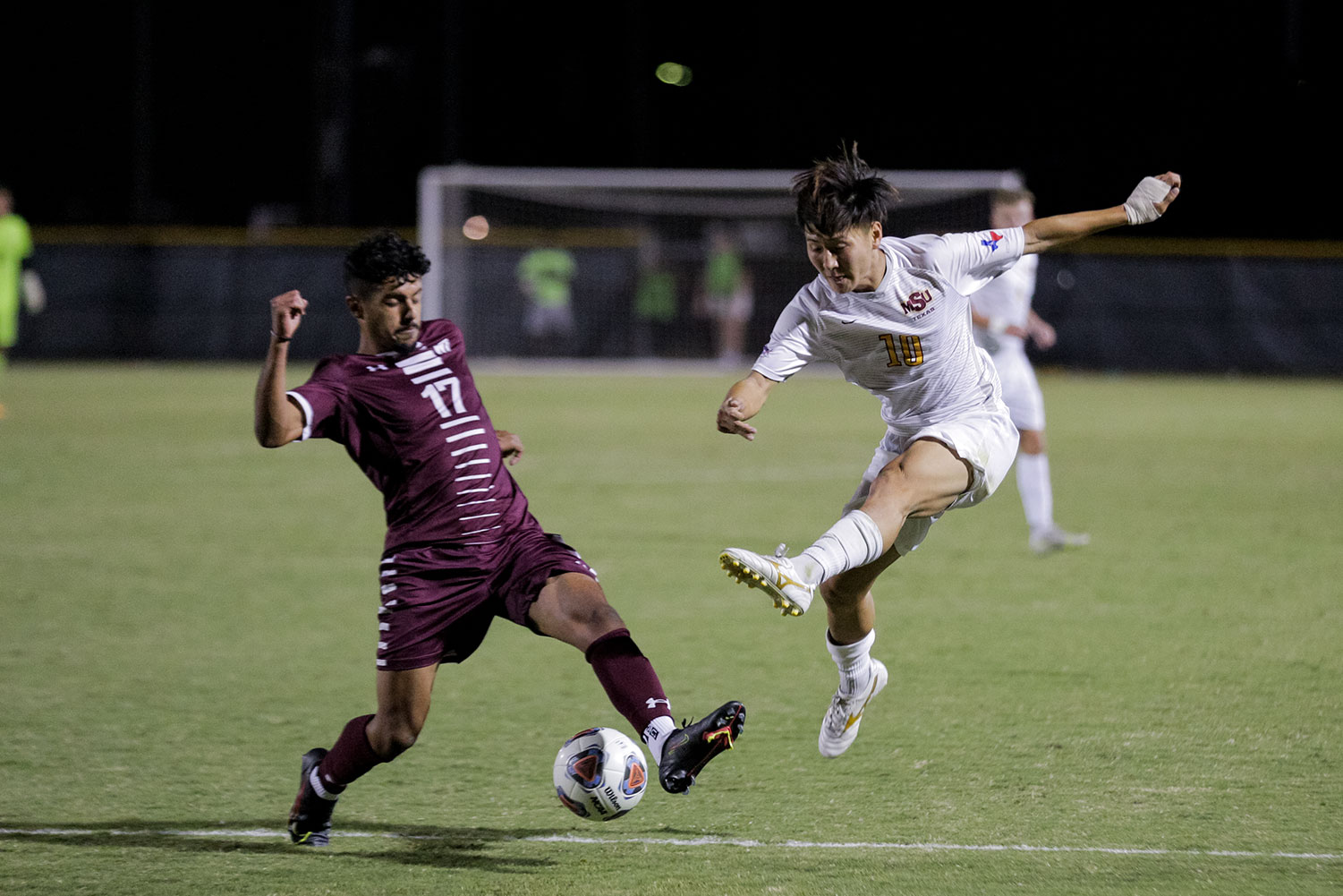 Sport and leisure studies senior and forward Toi Yamaoka leaps after he passes the ball to a teammate and sends it closer to West Texas A&M's goal