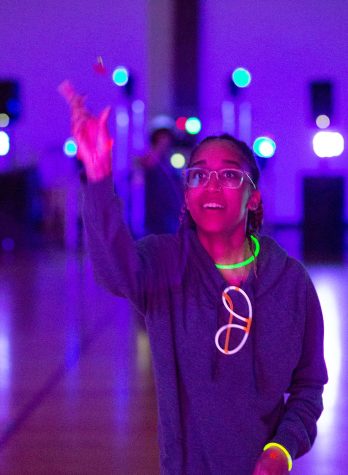 Early education sophomore Alexis Willis plays darts at Glowcade.