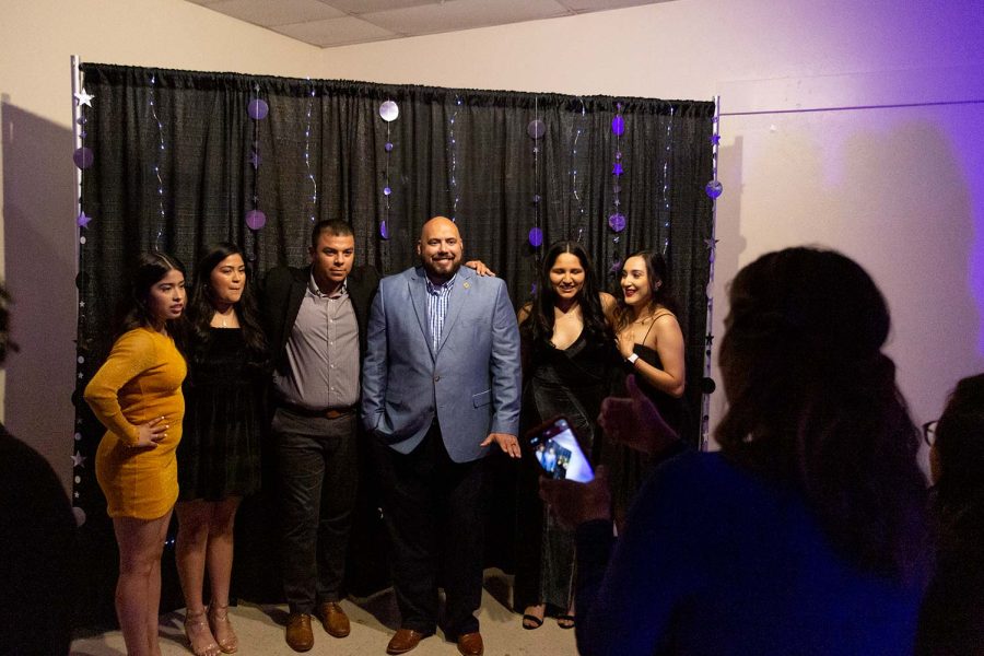 People gather together to take photos at one of the available backdrops at the Noche de Estrellas gala.