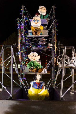 Snow White and the Seven Dwarves sit on a miniature ferris wheel at the 2021 MSU Fantasy of Lights.