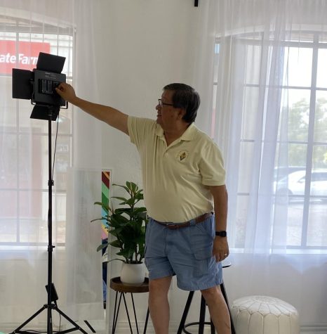 Owner of the Sun Catcher Studio Harry Tonemah adjusts a light used for photography.