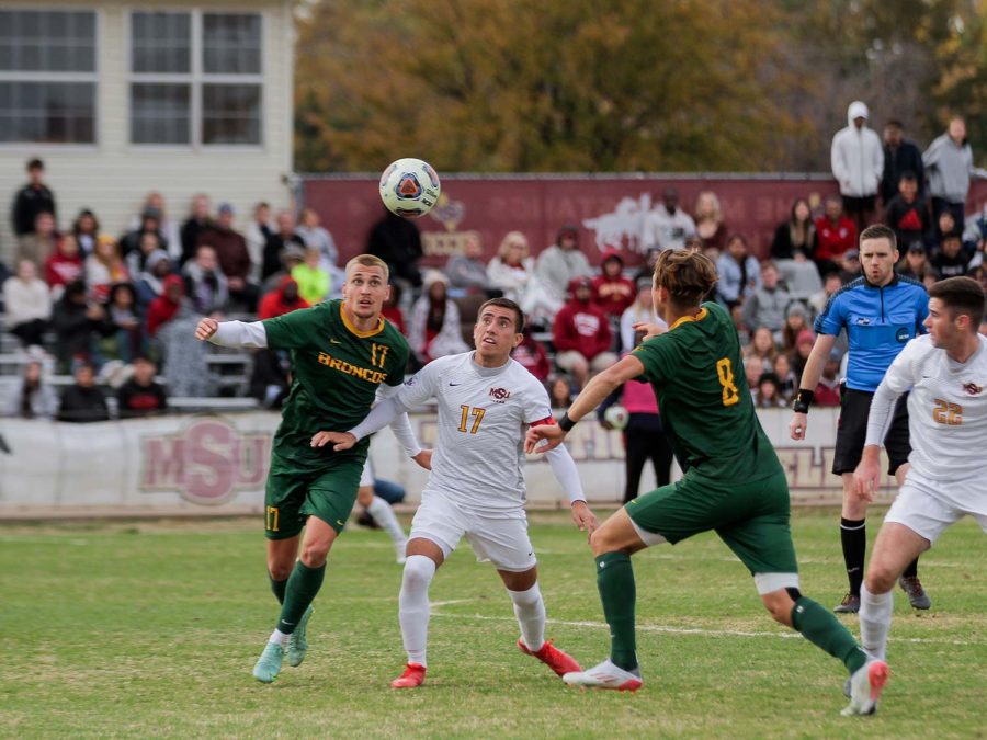 Kinesiology senior and midfielder Carlos Flores prepares for a high kick to keep the ball away from opposing Cal Poly Pomona players.