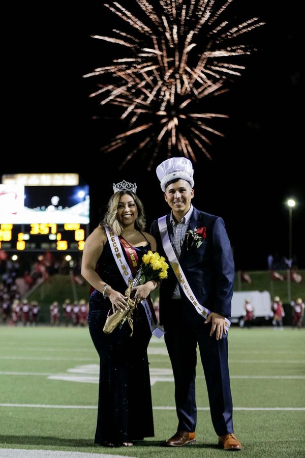 Fireworks explode in the night sky behind respiratory care senior Acelynn Medrano and management information systems senior Dallas Torres, who were crowned Homecoming Queen and King, respectively.