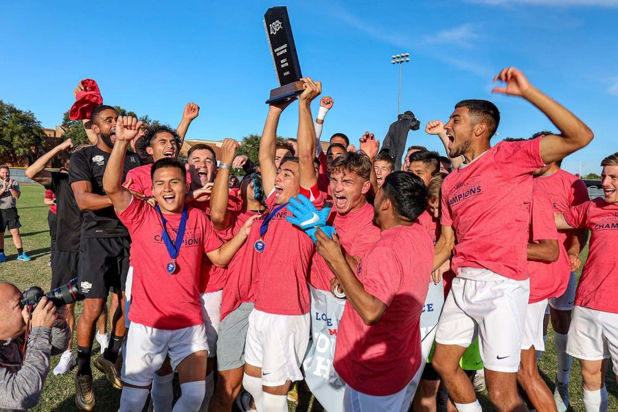 Kinesiology+senior+and+midfielder+Carlos+Flores+holds+up+the+Stangs+trophy+as+he+and+his+team+celebrate+their+victory+against+Lubbock+Christian+University+which+made+them+champions+of+the+regular+season+and+Lone+Star+Conference+Postseason+Tournament.