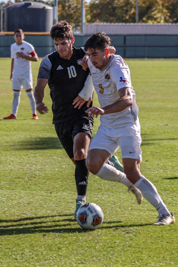 Mathematics senior and forward Trevor Amann fights with an opposing Lubbock Christian player for the ball.