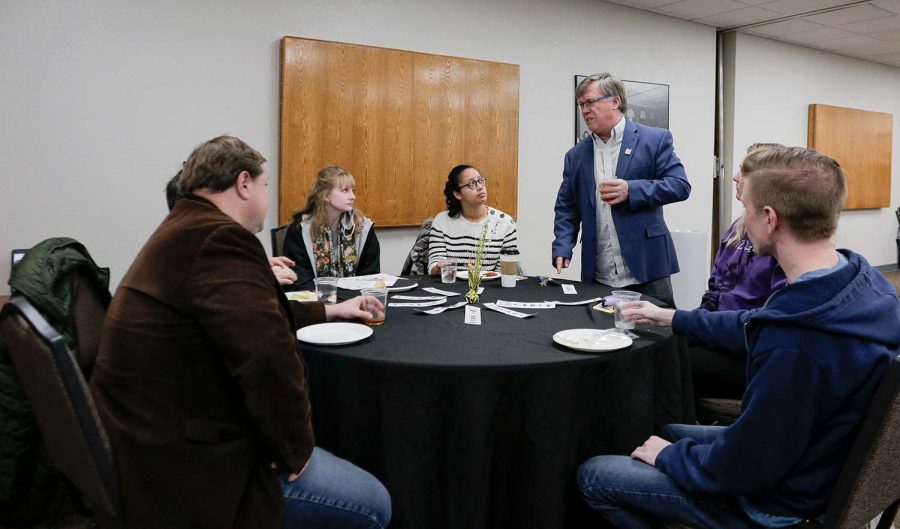 Associate professor Bradley Wilson talks with various other guests at the Core Values celebration, Feb. 18.
