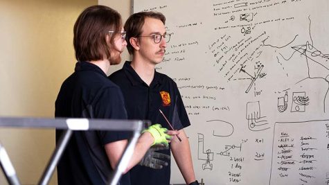 Mechanical engineering senior and chief engineer Trevor Snyder and mechanical engineering sophomore and executive director Chris Paulson discuss their FSAE project at the Sikes Lake recreation center workshop, Feb. 1.