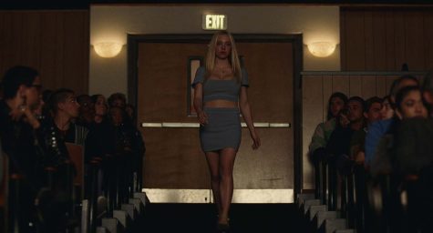 Cassie Howard, played by Sydney Sweeney, walks towards the stage to interrupt a play, 2022.