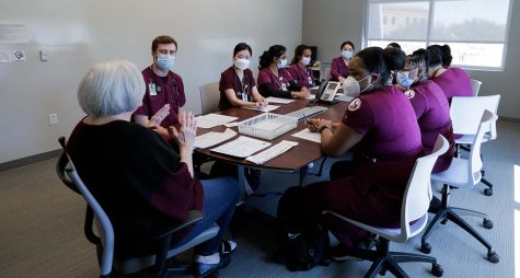 Nursing students prepare for a simulation and listen to a debrief, Mar. 10.