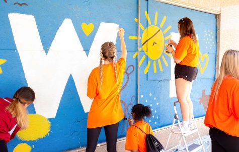 Students help paint murals with Downtown Wichita Falls Development.