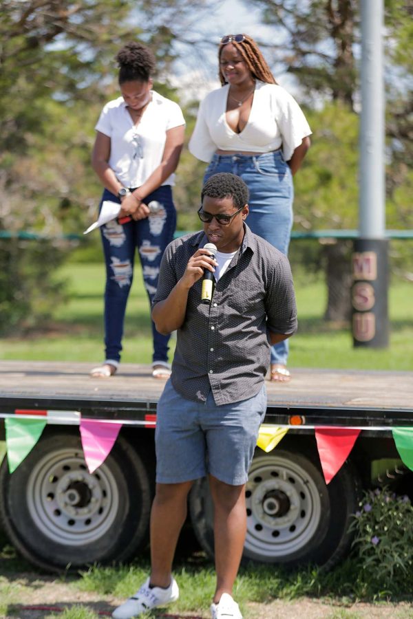 CSO senator and mechanical engineering freshman Vincent Peter opens the launch in prayer with radiology senior Ebany Hanna and mass communication senior Neila Jones in the background, Sept. 3.
