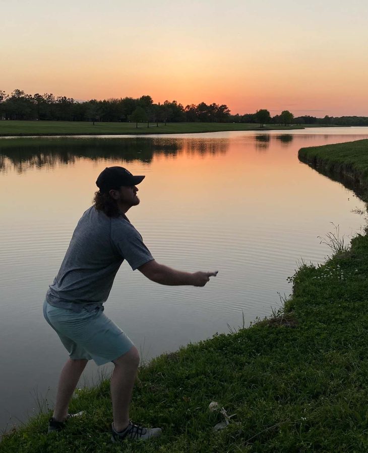 Nursing senior Nic Hubbert tries to send his disc closer to the goal as the sun sets behind him, 2022. Photo courtesy of Nic Hubbert.