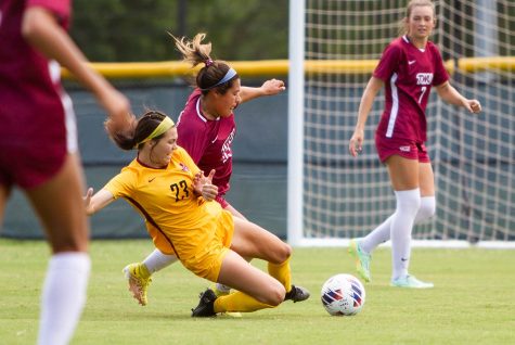 Management sophomore and midfielder Lexi Beck dives to kick the ball before an opposing Texas Womens player can reach it, Sept. 4.