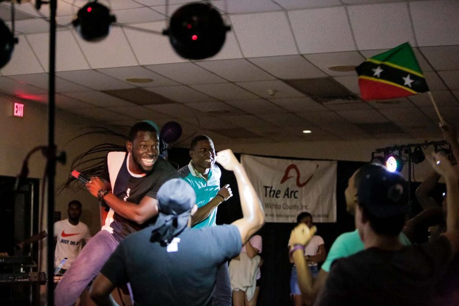 Hosts and mechanical engineering sophomore Vincent Peter and senior Trevon Antoine dance before revealing the results of the Soca Show, Sept. 23.