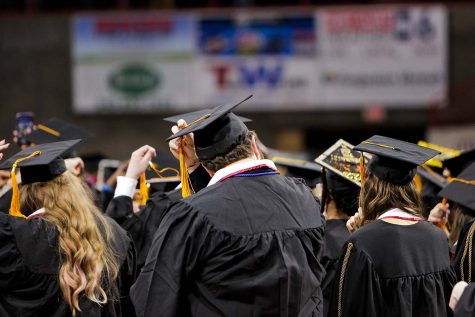 Previous undergraduates move their tassels to the left, signifying their promotion to graduates, Dec. 10.