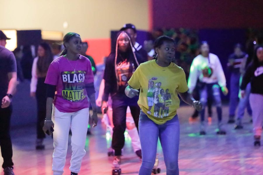 Exercise physiology junior Dejah Burnley and child and adolescent studies senior Jordan Ingram dance to "Crank That (Soulja Boy)" as they skate around the rink, Feb. 16. Many popular songs were played at the event.
