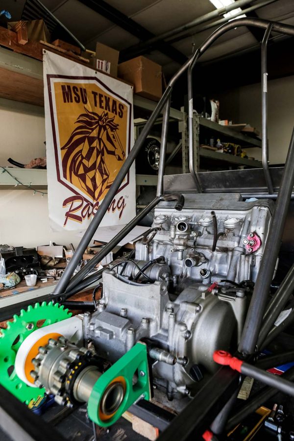 A repurposed motorcycle engine sits in the chasis for MSU Texas Racings new car, March 21. The engine had 3D printed parts attached for checking measurements, to be replaced with more durable metal parts once the fit is finalized.