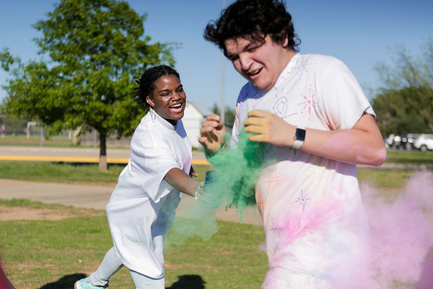A runner passes through multiple dust clouds, April 12. The color run event has been a longstanding event at MSU.