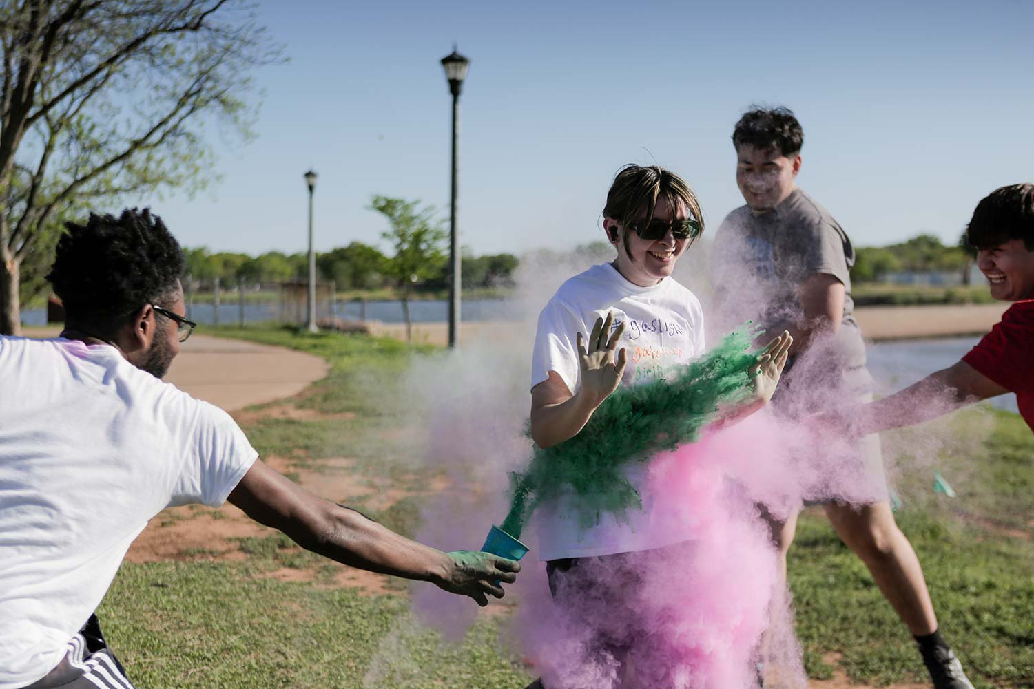 A student runs through a dust cloud after hitting a checkpoint, April 12. Runners were allowed to customize their shirts before the run to add to the color spots left by the dust.