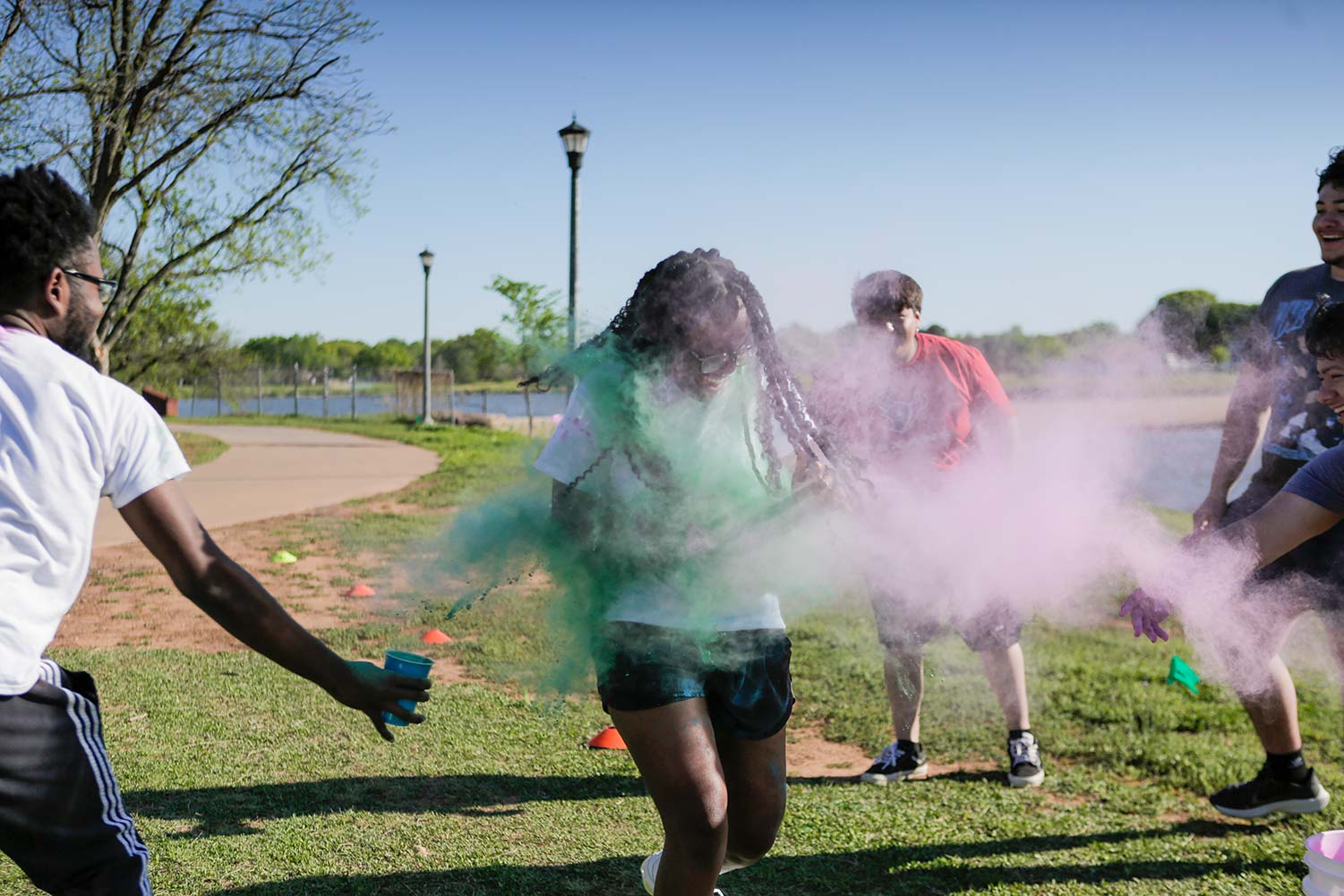 A runner laughs as they pass through a dense dust cloud, April 12. Beyond fun, the color run supported First Step, an organization that supports domestic violence and sexual assault.