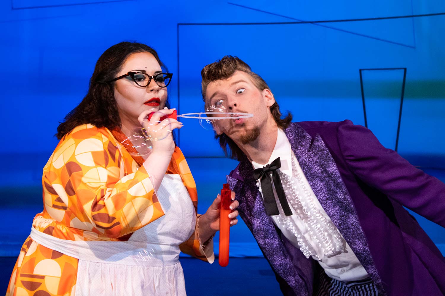 Angela Webb as Johanna Rugby and Luke Craddock as Abraham Slender blow bubbles, April 27. "Merry Wives of Windsor" is one of Shakespeare's comedies.