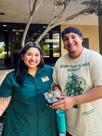 WFMA education coordinator Sarah Griego and MSU alumni Christopher Astudillo display a painting made at the outdoor painting event, May 11.