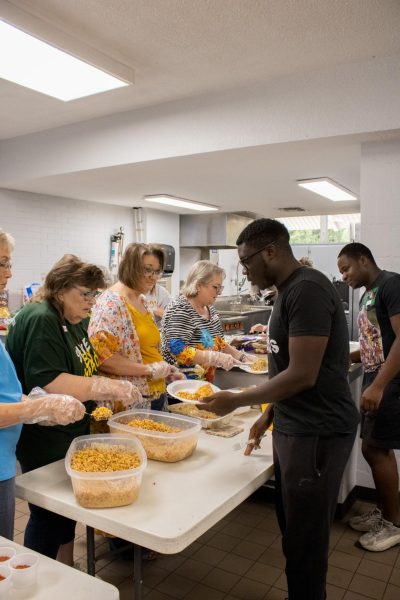 Faith Baptist Church members serve students their free lunch, Sep.13.