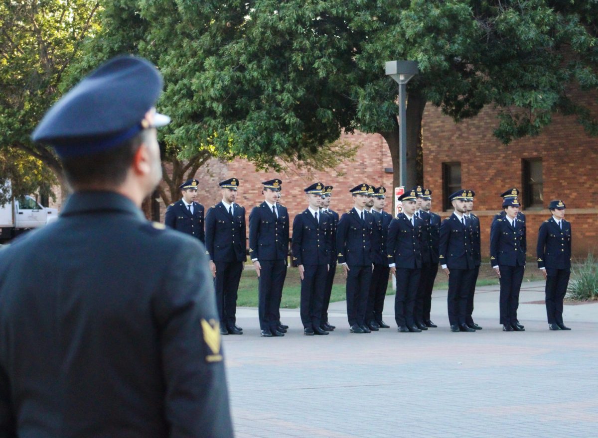 Members of Italian Air Force stand in honor of the Italian national anthem, Oct. 6.