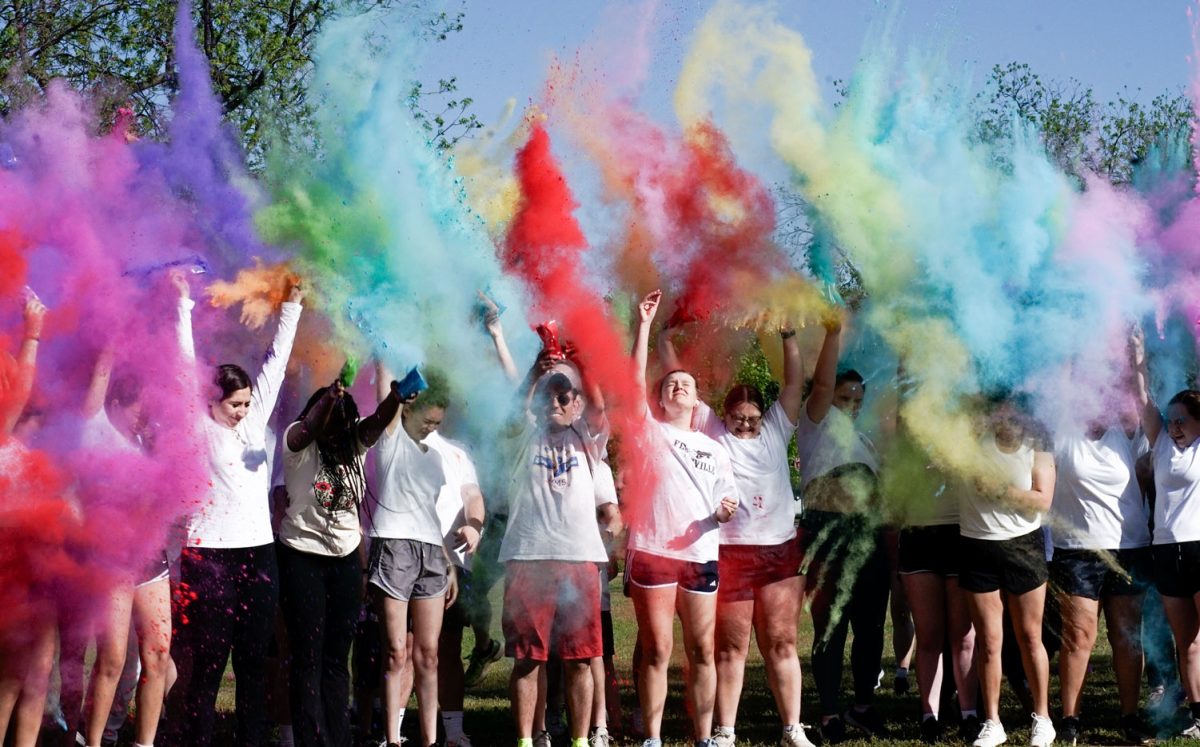 Wichita Falls community members toss colored powder before the run starts, April 11. The Kolor Run was a fundraiser for the Childrens Aid Society of Wichita Falls.
