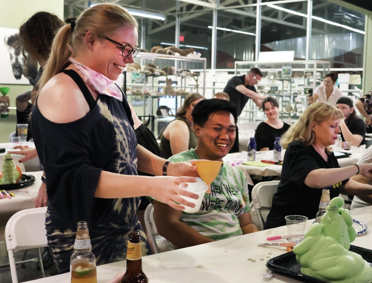 Kari Richard and Raul Maderang smiling at their elephant toothpaste erupting at the Sip n' Science event at the Red River Center, Sept. 27. 