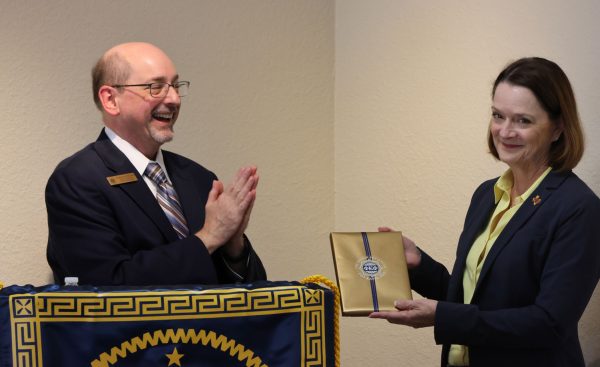 President Haynie recieves a plaque from Phi Kappa Phi executive director Dr. Bradley Newcomer on behalf of MSU, Oct. 10.