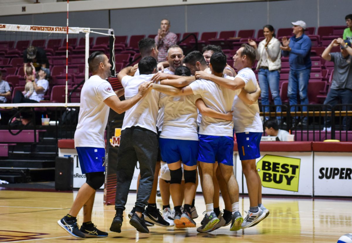 The Sheppard Air Force team jumps in celebration after winning the volleyball game, taking home the trophy, Nov. 8.